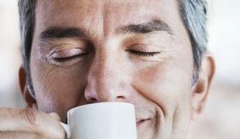 Businessman smelling espresso coffee